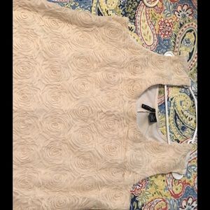 Under Jacket or sweater shell. Cream in color